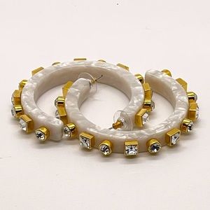 Lele Sadoughi MOP acetate hoops with crystal embellishments.